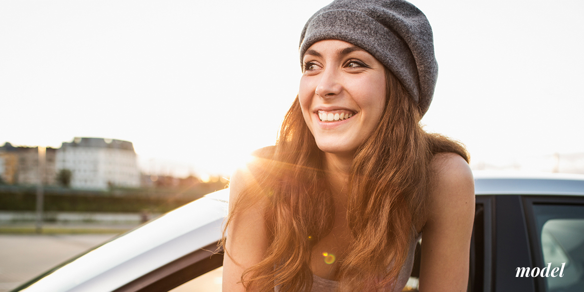 Female Model Leaning Out of Car in Sun